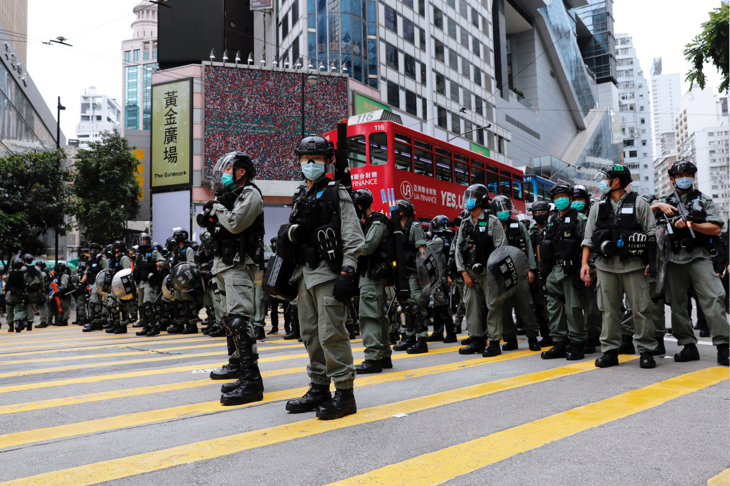 Riot police stand guard during a march against Beijing's plans to impose national security legislation in Hong Kong