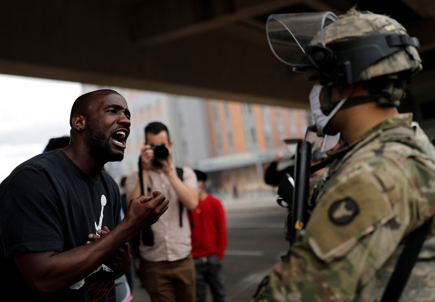 A man confronts a National Guard member guarding the area in the aftermath of a protest against the death in Minneapolis police custody of African-American man George Floyd