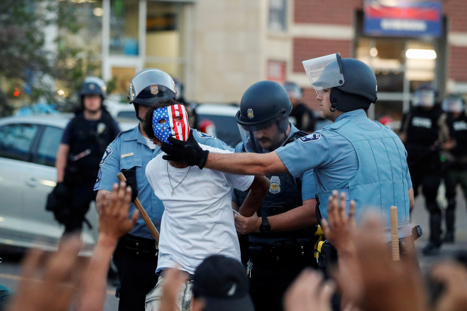 A protester is detained by police officers during a rally against the death in Minneapolis police custody of George Floyd, in Minneapolis, Minnesota A protester is detained by police officers during a rally against the death in Minneapolis police custody of George Floyd, in Minneapolis, Minnesota